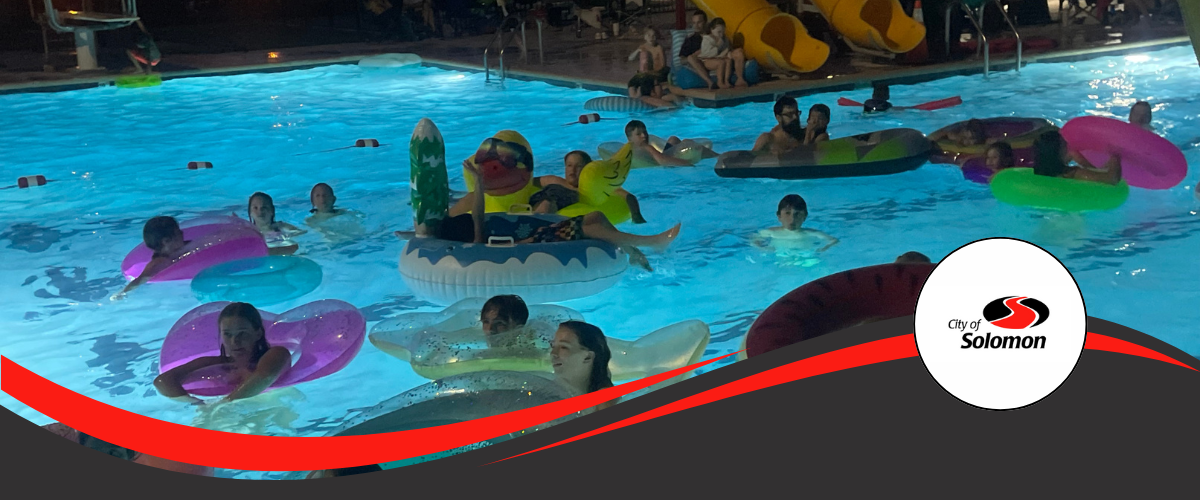 2024 Dive In Movie Night - attendees float in pool in floaties