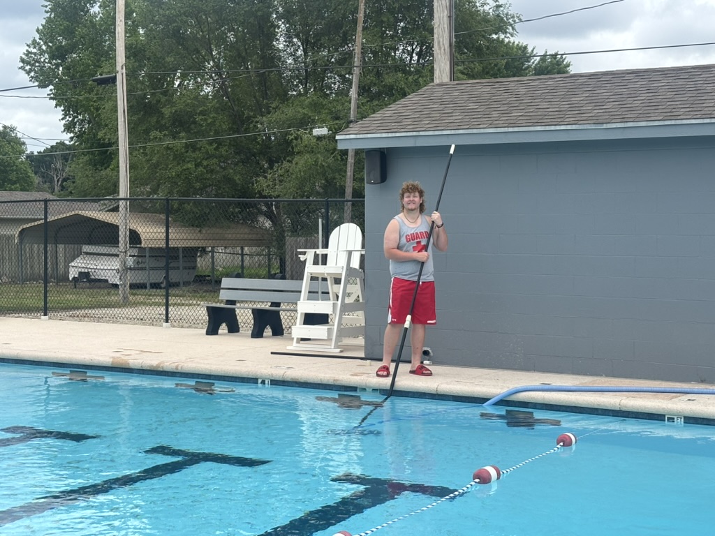 Life Guard cleans pool
