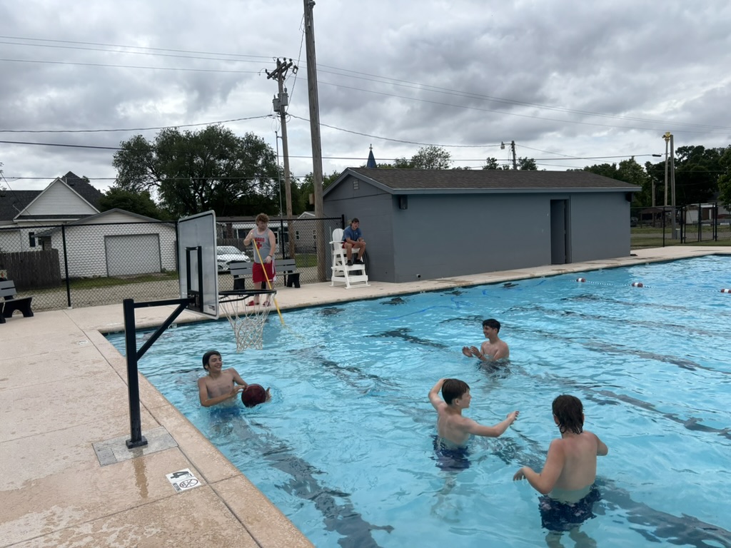 group of boys shooting hoops at municipal pool
